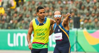 Para athlete Lucas Prado and his guide Anderson Machado from Brazil celebrate victory in the Lima 2019 men’s 100 m T11 final at the National Sports Village - VIDENA