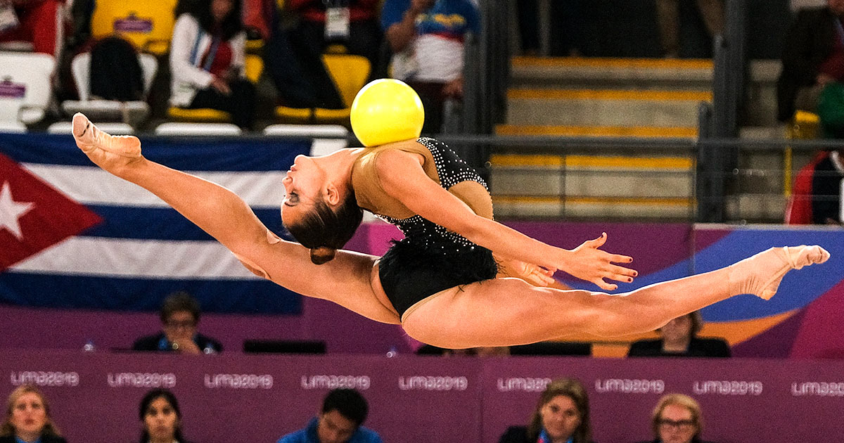 Cuban Gretel Mendoza of Cuba soars through the air with a ball in the rhythmic gymnastics’ competition at Lima 2019.