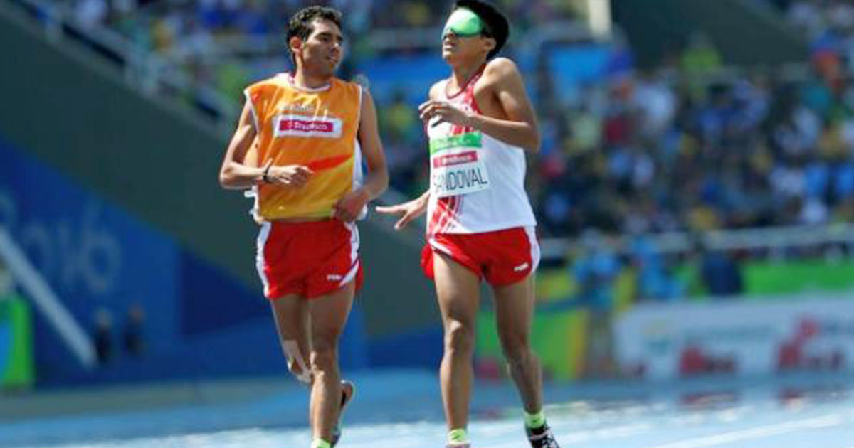 Luis Sandoval and his guide running during Para athletics competition at the Rio 2016 Paralympic Games