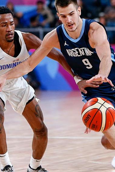 Dominican Luis Montero and Argentinian Nicolas Brussino disputing the ball in Lima 2019 basketball competition at Eduardo Dibós Coliseum.