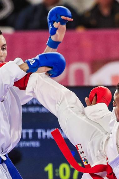 Anderson Soriano from the Dominican Republic competes against his US opponent, Thomas Scott, in karate at the Lima 2019 Games, at the Villa El Salvador Sports Center.