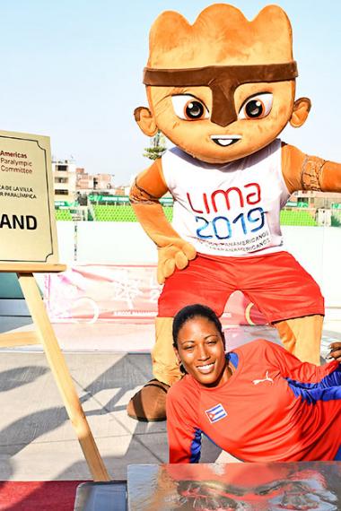 Cuban Para athlete Omara Durand poses next to the plaque of honor at the National Sports Village - VIDENA