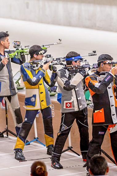 Shooters from the Americas compete at the men’s 10 m air rifle final at the Chorrillos Military School.
