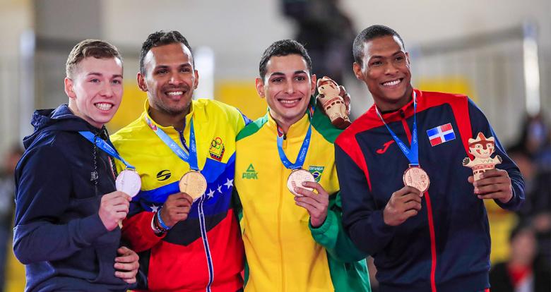 Camilo Velozo from Chile, Andrés Madera from Venezuela and Vinicius Figueira and Deivis Ferreras from the Dominican Republic show their medals for karate at the Lima 2019 Games, at the Villa María del Triunfo Sports Center.