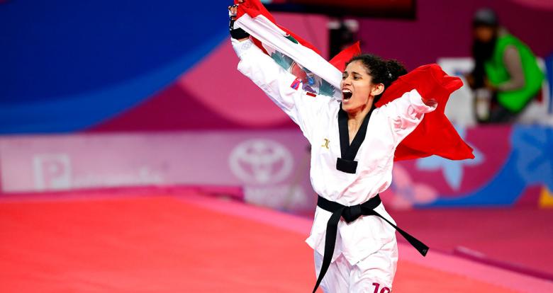 Angélica Espinoza celebrates her gold medal in Lima 2019 women’s Para taekwondo K44 -49kg by carrying the Peruvian flag in the Callao Regional Sports Village.