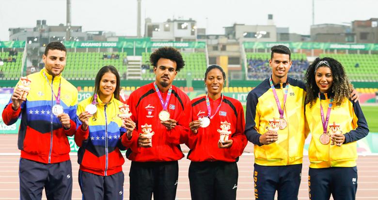 Paula Pereira and her guide Rodrigo Chieregatto from Brazil, Greimal Villarroel and her guide Roberto Medina from Venezuela, and Omara Durand and her guide Yuniol Kindelán from Cuba took the bronze, silver and gold medals, respectively. Para athletes pose with their medals in the Lima 2019 women’s 400 m T12 competition at the National Sports Village - VIDENA