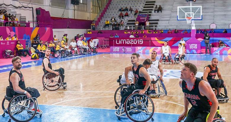 The Canadian players watch the ball enter the basket during their wheelchair basketball game against Colombia at the National Sports Village – VIDENA, at Lima 2019