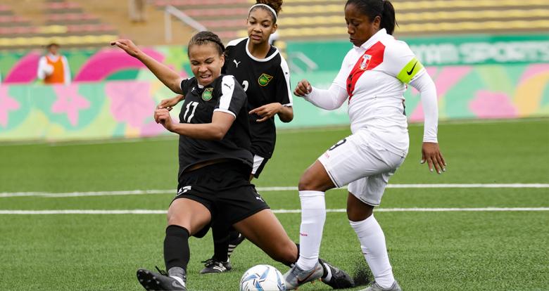 Steffani Otiniano Torres from Peru faces off Sashana Campbell from Jamaica during the Lima 2019 football match at the San Marcos Stadium