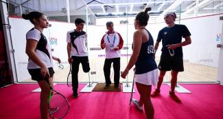 Athletes from USA and Peru talk after squash competition at Lima 2019
