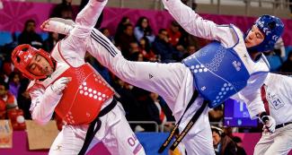 Christian Ocampo faces Juan Alvarez from Puerto Rico in men's taekwondo competition