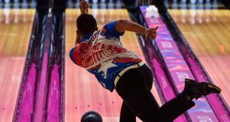 Donald Lee Pan throws the ball at the center of the bowling lane