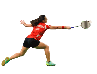 Athlete holds her racket and is about to hit the shuttlecock during a badminton match. 