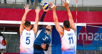 Pedro Nieves from Argentina faces Jan Martínez and Maurice Torres from Puerto Rico in a volleyball match held at the Callao Regional Sports Center at the Lima 2019 Pan American Games.
