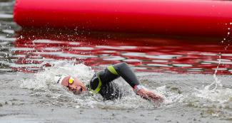 A swimmer moving through the water in the 10 km open water final held at Laguna Bujama