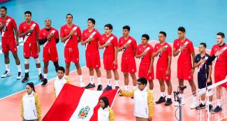 Peruvian volleyball team players put their hand over their heart while singing the Peruvian national anthem before the match against Cuba, held at the Callao Regional Sports Village at the Lima 2019 Pan American Games.