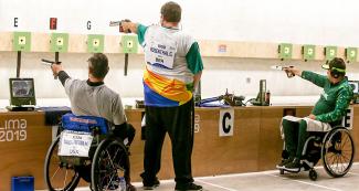 Michael Tagliapietra from the US, Geraldo Rosenthal and Adriano Sergio from Brazil competing in men’s 10 m air pistol event held at Las Palmas Air Base at Lima 2019