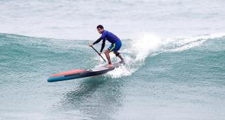 Vinicius Martins from Brazil showing his skills over the waves in the men’s SUP surfing competition in Punta Rocas