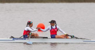 Rowers Antonia Abraham and Melita Abraham congratulate each other after winning gold in the Lima 2019 coxless pairs final at Laguna Bujama