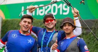 Juan Painevil Navarro, Ricardo Soto Pedraza and Andrés Aguilar Gimpel of the recurved bow Chilean team celebrating at the Villa María del Triunfo Sports Center, Lima 2019 Games