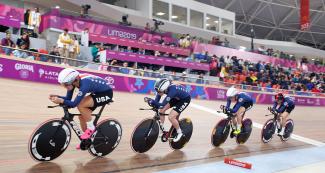 Cyclists Cristina Birch, Chloe Digest, Kimberly Geist, and Lily Williams compete at speed along track cycling circuit to finish Lima 2019 race