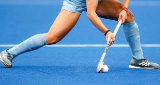  Argentinian hockey player carries the ball at the Villa María del Triunfo Sports Center during the Lima 2019 Pan American Games.