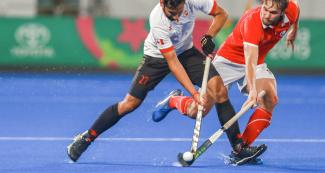 Singh Panesar from Canada faces Chilean Felipe Renz during the hockey semifinal at the Villa María del Triunfo Sports Center, Lima 2019 Games