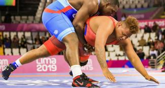 Greco-Roman wrestling competition between Cuba’s Mijain Lopez and Venezuela’s Moises Perez at the Lima 2019 Games at the Callao Regional Sports Village