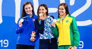 Maria Denigan from the USA (silver), Delfina Pignatiello from Argentina (gold) and Viviane Eichelberger from Brazil (bronze) celebrate their Lima 2019 medals in women’s 800 m freestyle at the National Sports Village – VIDENA