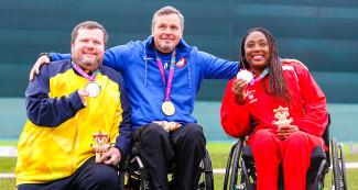 Geraldo Rosenthal from Brazil (silver), Michael Tagliapietra from USA (gold) and Yenigladys Suarez from Cuba (bronze) proudly pose on the podium showing their medals of the mixed 25 m sport pistol SH1 at Las Palmas Air Base, at Lima 2019.