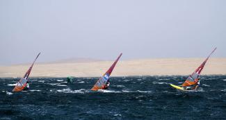 Demita Vega of Mexico, Celia Tejerina of Argentina and María Bazo of Peru compete in the Lima 2019 women’s windsurf competition at Paracas Bay