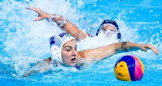 Diana Abla from Brazil fights for the ball against USA during a women’s preliminary water polo match at the Lima 2019 Games