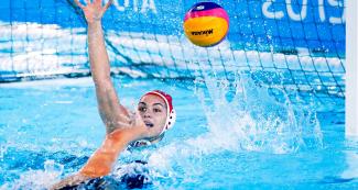 American Stephanie Haralabidis scores a goal against Brazil during the water polo preliminary round at the Lima 2019 Games at Villa María del Triunfo Sports Center. 