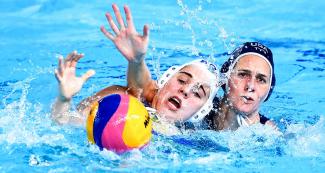 Mariana Duarte from Brazil and Alys Williams from USA fight for the ball during a preliminary water polo match at the Lima 2019 Games, at the Villa Maria del Triunfo Sports Center