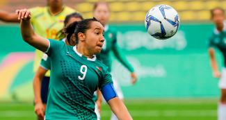 Verónica Corral from Mexico focuses on kicking the ball during the Lima 2019 Games football competition at San Marcos Stadium