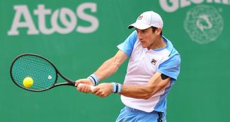Argentinian Facundo Bagnis hits the ball coming from his Brazilian opponent in the men's singles semifinal at the Lima 2019 Games, held at Lawn Tennis Club