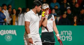 Peruvians Sergio Galdos and Anastasia Iamchkine talking during the mixed doubles match against the Guatemalan pair at the Lawn Tennis Club.