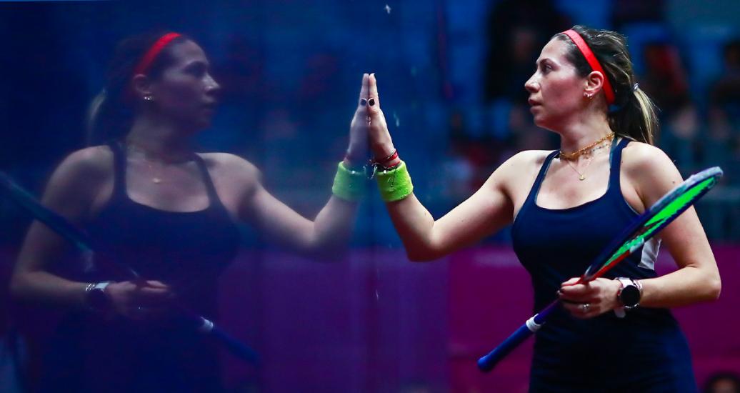 Ana Pinto looks at her own reflection before starting the squash competition
