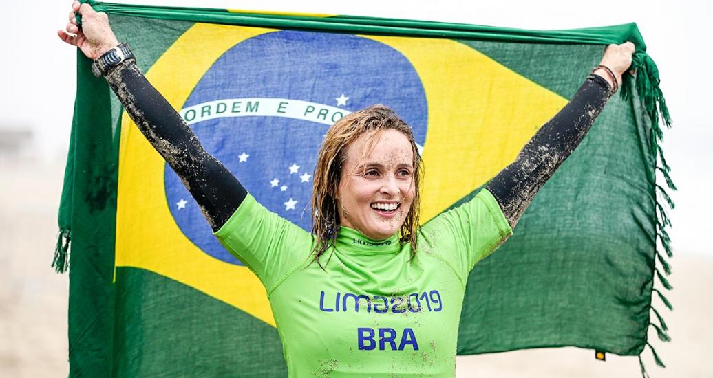 Lena Guimaraes from Brazil celebrates gold in women’s SUP surfing in Punta Rocas