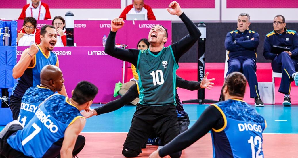 Brazilian Renato De Oliveira celebrates with his team after scoring a point during a sitting volleyball match against Costa Rica, held at Callao Regional Sports Village at the Lima 2019 Parapan American Games