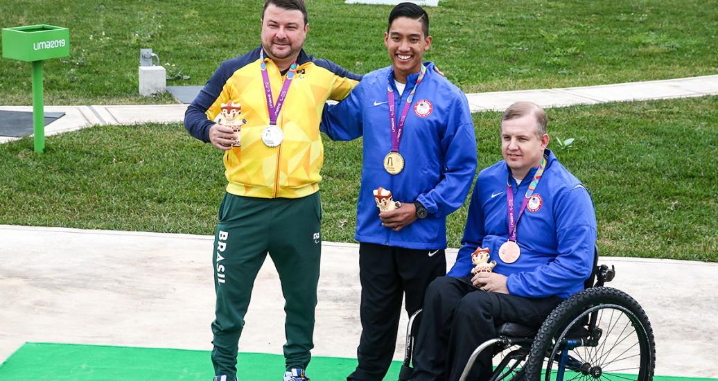Robert Beach from the US (bronze), Carlos Garletti from Brazil (silver) and Kevin Nguyen from the US (gold) with their 50 m rifle prone medals at Las Palmas Air Base at Lima 2019