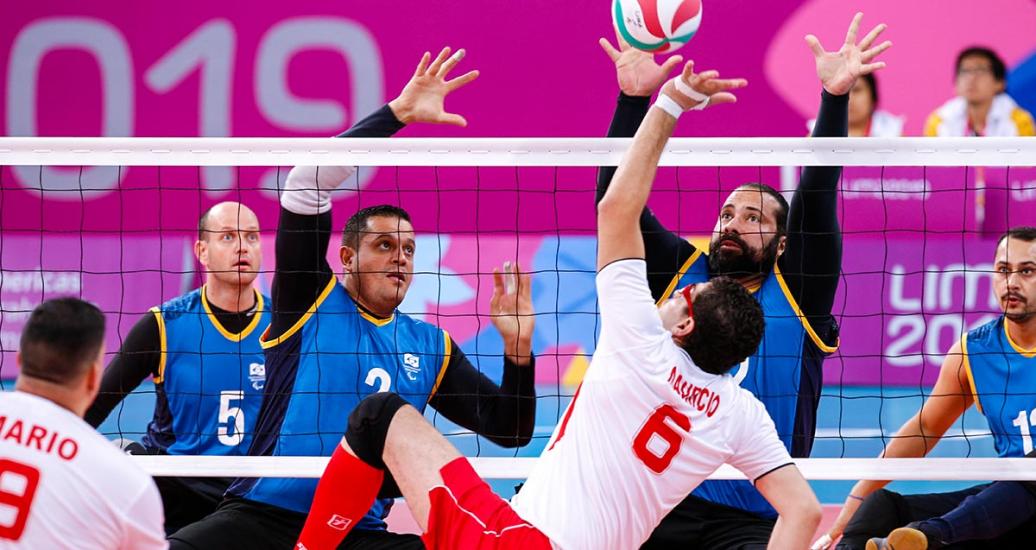Mauricio Gomez from Costa Rica faces off Diego Reboucas and Leandro Da Silva from Brazil in sitting volleyball at the Lima 2019 Parapan American Games, at Callao Regional Sports Village
