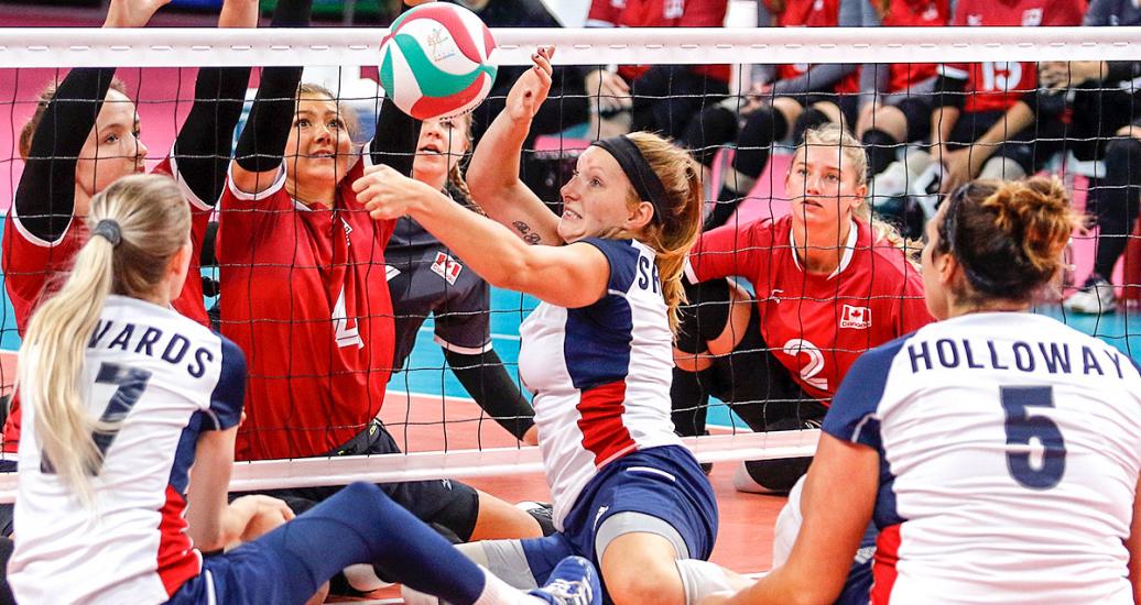 Para athletes from the US and Canada focused on the ball in the Lima 2019 sitting volleyball match held at the Callao Regional Sports Village
