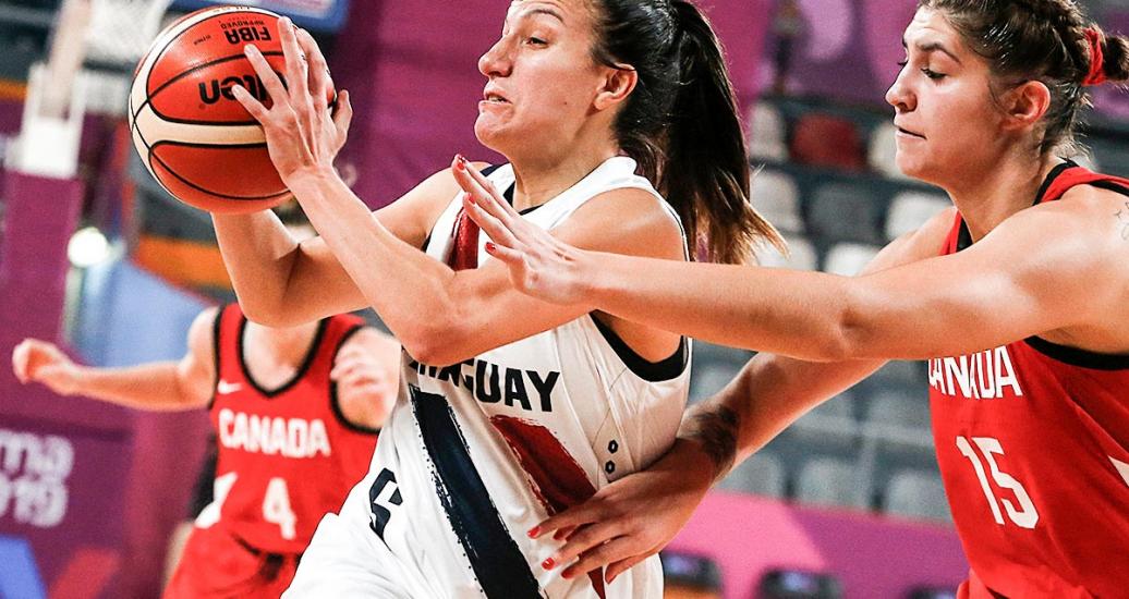 Uruguayan Paola Ferrari fights Canadian Emily Potter for the ball during Lima 2019 basketball match at the Eduardo Dibós Coliseum