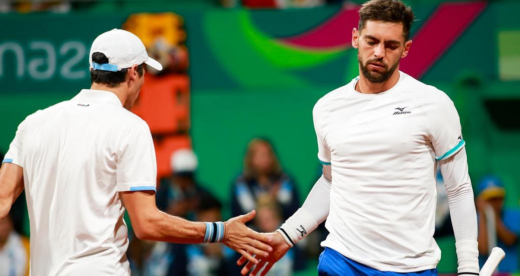 Facundo Bagnis and Guido Andreozzi from Argentina high-fiving during the Lima 2019 tennis competition at the Lawn Tennis Club