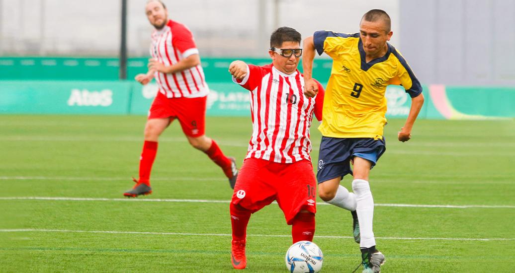Colombian Camilo Garcia fights for the ball with Peruvian Diego Guzman in football 7-a-side at the Villa María del Triunfo Sports Center, at Lima 2019