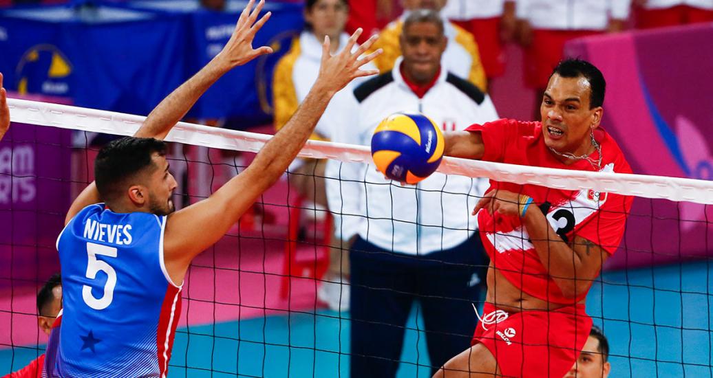 Peruvian volleyball player Benny Bernaola jumps to hit the ball during a match against Puerto Rico played at Callao Regional Sports Village at the Lima 2019 Games.