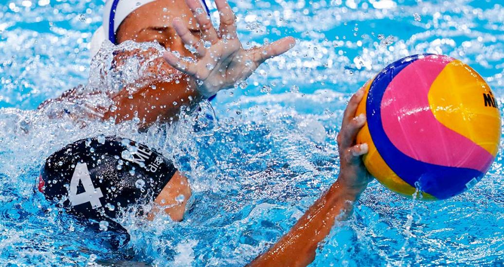 Mexican Edith Flores Livas and Cuban Aliannis Ramirez fight for the ball in a water polo group stage match at the Lima 2019 Games, held at the Villa María del Triunfo Sports Center 