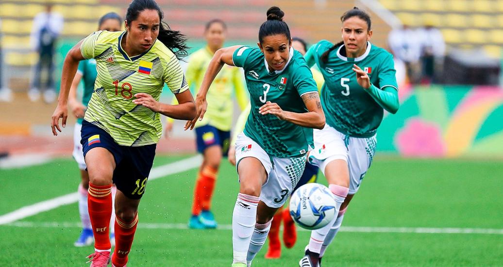 Colombian Mayra Ramirez and Mexican Bianca Sierra dispute the ball at San Marcos Stadium, at the Lima 2019 Games