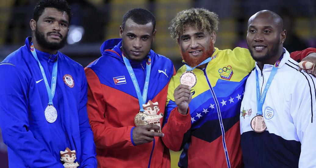 Proud athletes from USA (silver), Cuba (gold), Venezuela and Honduras (bronze) show their medals after competing in Greco-Roman wrestling at the Callao Regional Sports Village